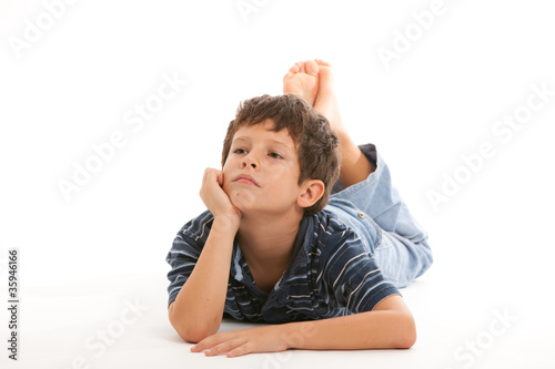 Photo: Cute thinking boy on a white background Cute thinking boy on a white background