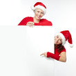 Two beautiful women with santa hat presenting copyspace