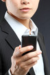 business man in black suit working on pda or smartphone