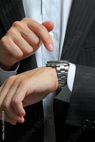 Photo: men's hand with a watch. men's hand with a watch.