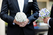 Groom and a bestman holding flowers during the wedding ceremony Groom and a bestman holding flowers during the wedding ceremony