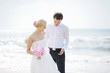 Beach wedding: bride and groom by the sea