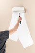 Woman painting a wall with a roller Woman painting a wall with a roller