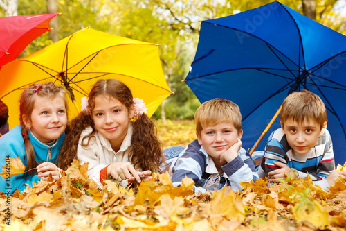 Photo: Kids group under umbrellas Kids group under umbrellas