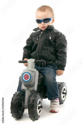 Photo: Girl on child's motorcycle Girl on child's motorcycle
