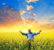 happy people among a yellow field at the sunset happy people among a yellow field at the sunset