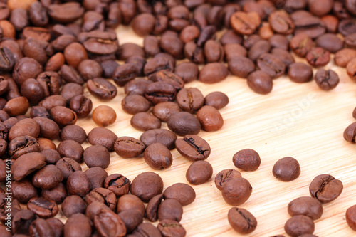 Photo: Coffee beans on wooden board Coffee beans on wooden board