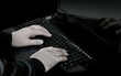 hacker with laptop in twilight
