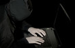 hacker with laptop in twilight