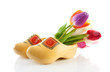 Pair of traditional yellow wooden shoes with colorful tulips