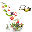Falling vegetables for salad and oil isolated on white Falling vegetables for salad and oil isolated on white
