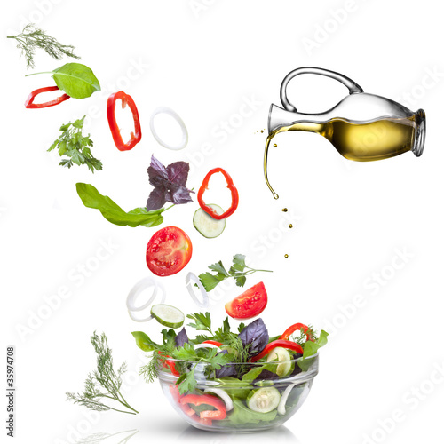 Фото: Falling vegetables for salad and oil isolated on white Falling vegetables for salad and oil isolated on white