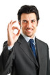 Businessman showing ok sign isolated on white Businessman showing ok sign isolated on white