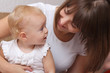 Adorable baby and mother in home
