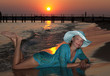 Beautiful girl on the seashore at sunset