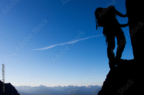 Photo: Silhouette of a climber with large copy space Silhouette of a climber with large copy space