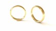 Dropped wedding rings isolated on the white. Slow motion