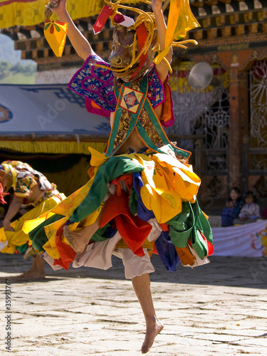 Photo: Bhutan - October 2010: Masked man are dancing on a tsechus (Bhut Bhutan - October 2010: Masked man are dancing on a tsechus (Bhut