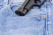Weapon barrel coming out of jeans pocket