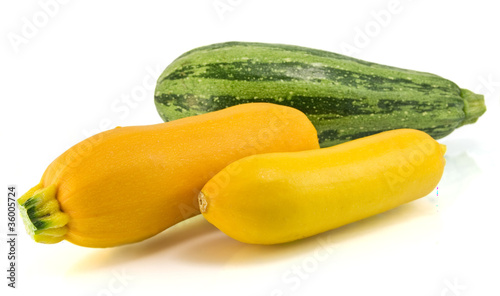 Photo: Yellow and Green zucchini isolated on white Yellow and Green zucchini isolated on white