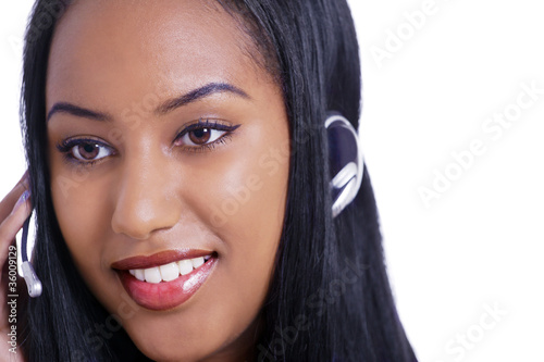 Photo: Telemarketing female on phone headset, face closeup Telemarketing female on phone headset, face closeup
