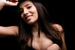Portrait of young beautiful woman smiling on black background