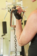 Woman using exercise equipment for arm curls