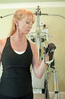 Attractive blond woman using exercise equipment