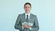 Businessman holding growing heap of dollar bills