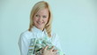 Pretty blonde holding heap of dollar bills in her hands