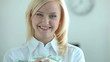 Happy blonde holding heap of dollar bills in her hands