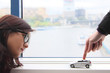 The finger moves the toy car