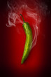 hot green pepper on a red background hot green pepper on a red background