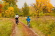 Family cycling outdoors, golden autumn in park