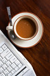Cup of coffee and white laptop