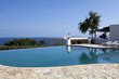 beautiful swimming pool surrounded by chairs and flowers