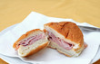 Soft bread roll with ham on a plate Soft bread roll with ham on a plate