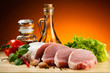 Raw pork on cutting board and vegetables