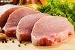Raw pork on cutting board and vegetables