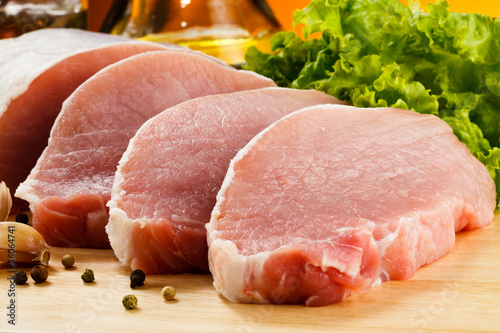 Photo: Raw pork on cutting board and vegetables Raw pork on cutting board and vegetables