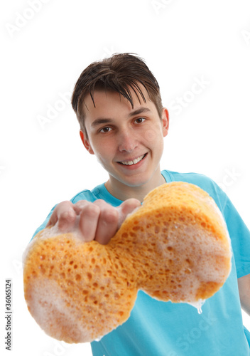 Photo: Boy using a soapy sponge to clean Boy using a soapy sponge to clean