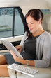 Executive businesswoman in car work touch tablet