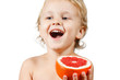 Little boy with a pink grapefruit on a white background