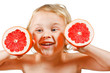 Little boy with a pink grapefruit on a white background