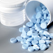 Foto: blue pills fallen out of the box blue pills fallen out of the box
