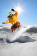 Snowboarder jumping against blue sky