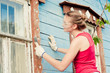 Young woman making cosmetic alterations of house
