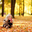 woman eat apple in autumn park