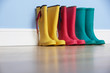 Wellingtons lines up against wall