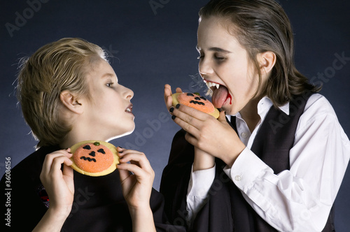 Photo: Boys eating Halloween cookies Boys eating Halloween cookies